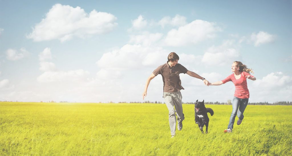 Boy, dog and girl running